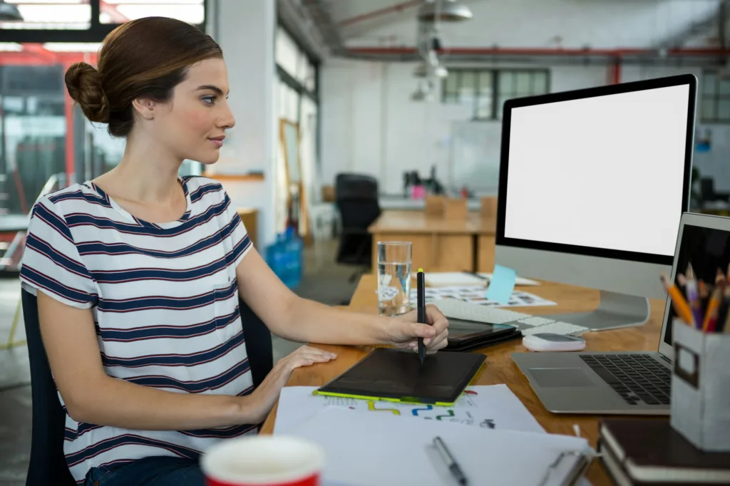 jpeg v vector - Graphic designer using graphic tablet and desktop
