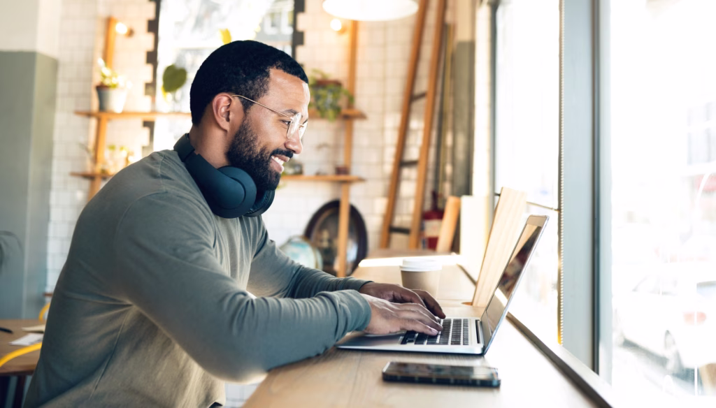 Person reviewing AI generated blog post on a laptop in a Northumberland office