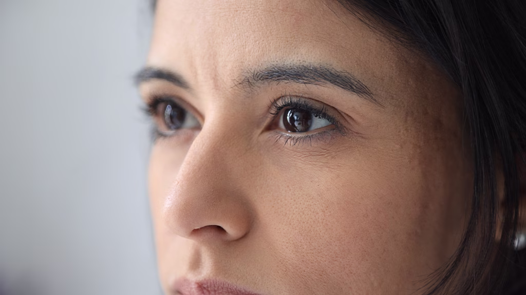 Young woman looking up with hope and expectation